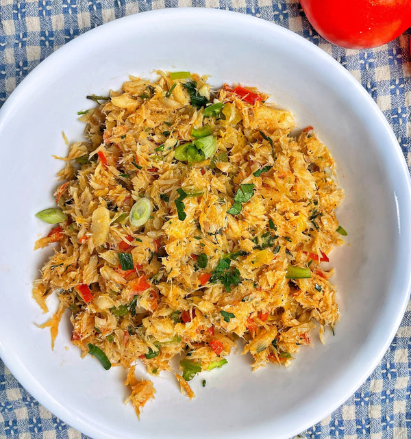 Guyanese fried bakes served with seasoned saltfish filling on a plate.